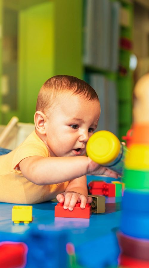 happy-baby-playing-with-toy-blocks-in-the-kindergarten-.jpg