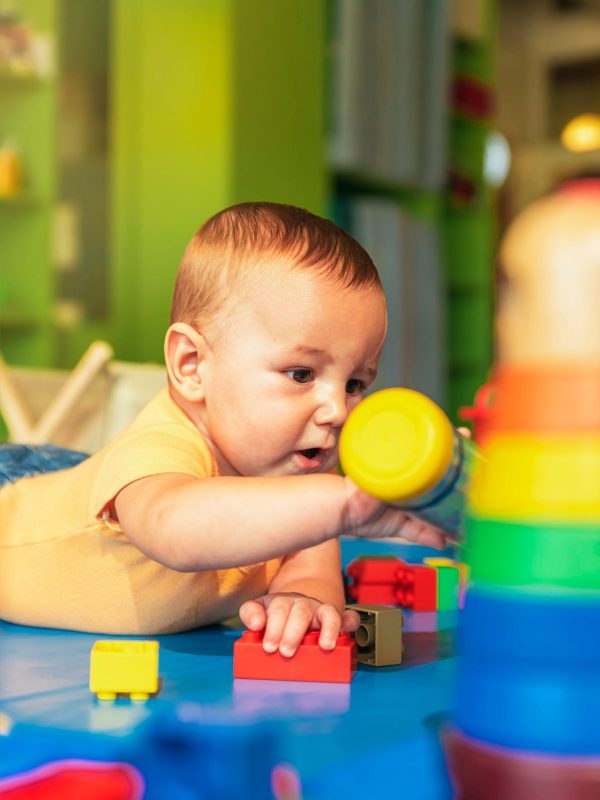 happy-baby-playing-with-toy-blocks-in-the-kindergarten-.jpg
